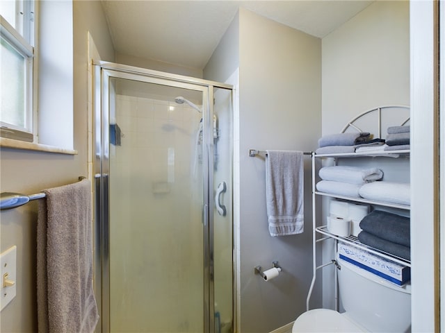 bathroom with toilet and walk in shower