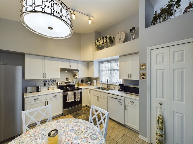 kitchen featuring white cabinetry, sink, a high ceiling, and appliances with stainless steel finishes