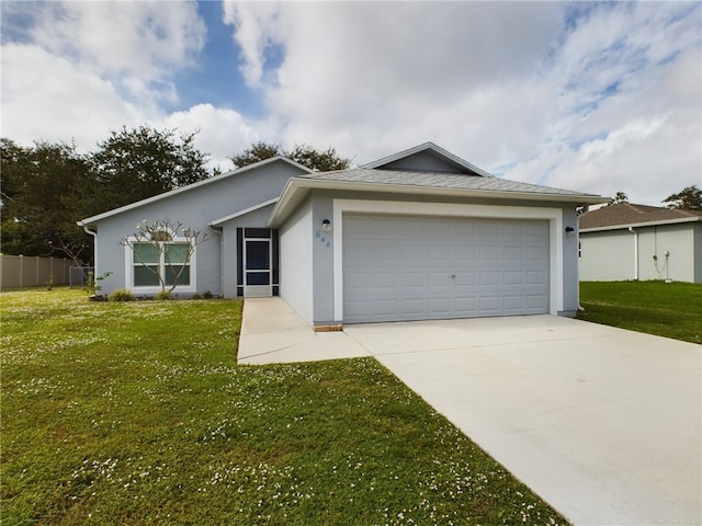 ranch-style house featuring a garage and a front lawn