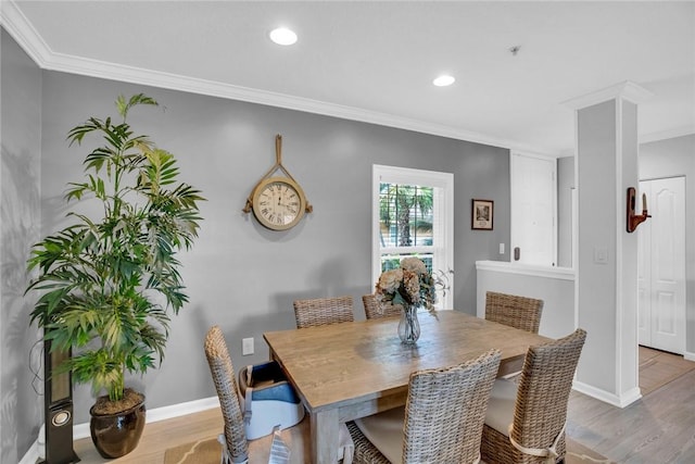 dining area with ornamental molding, baseboards, and wood finished floors