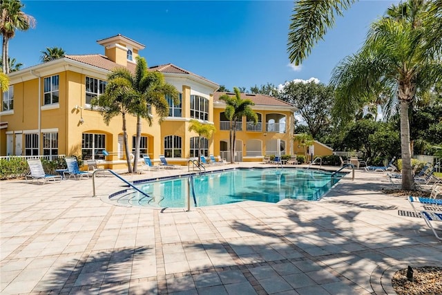 community pool with a patio area