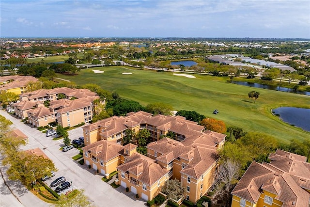 birds eye view of property with view of golf course, a water view, and a residential view