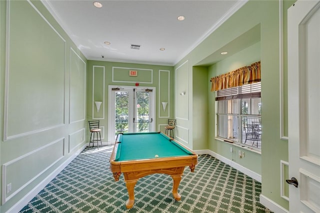 playroom featuring a decorative wall, carpet floors, visible vents, ornamental molding, and plenty of natural light