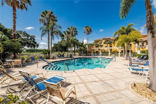 pool featuring fence and a patio