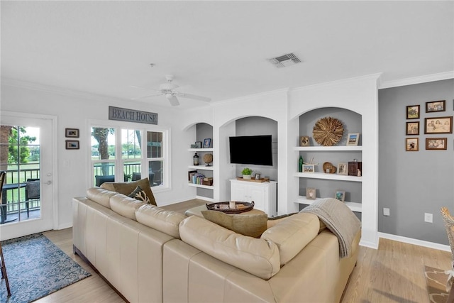 living room featuring baseboards, visible vents, ceiling fan, ornamental molding, and light wood-style floors