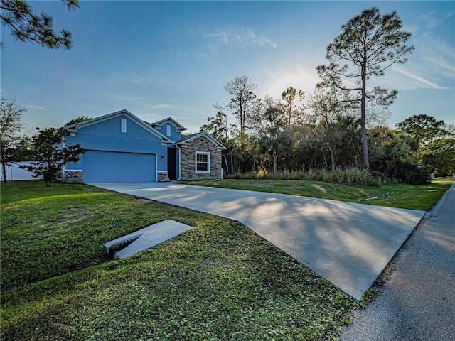 view of front of house featuring a garage and a front lawn