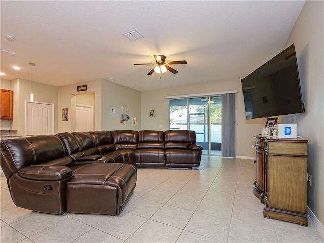 living room featuring baseboards, a ceiling fan, visible vents, and light tile patterned floors