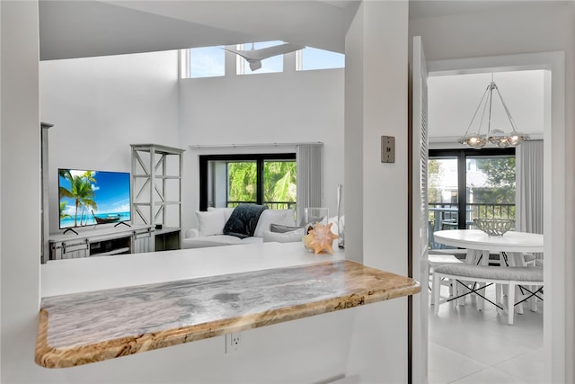 kitchen with hanging light fixtures, a notable chandelier, and light tile patterned floors