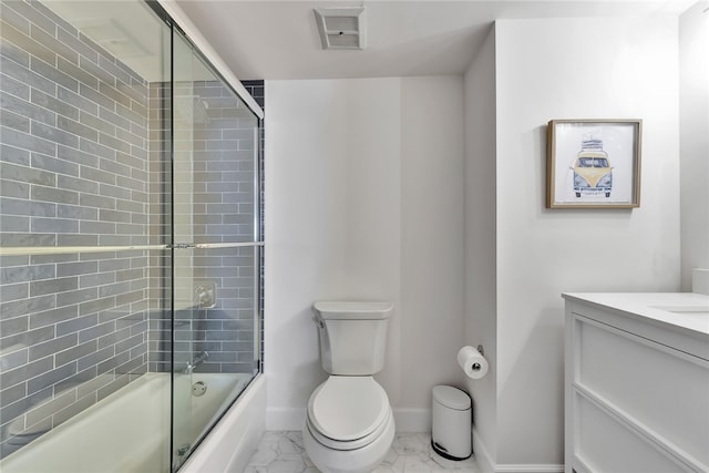 full bathroom featuring enclosed tub / shower combo, vanity, and toilet