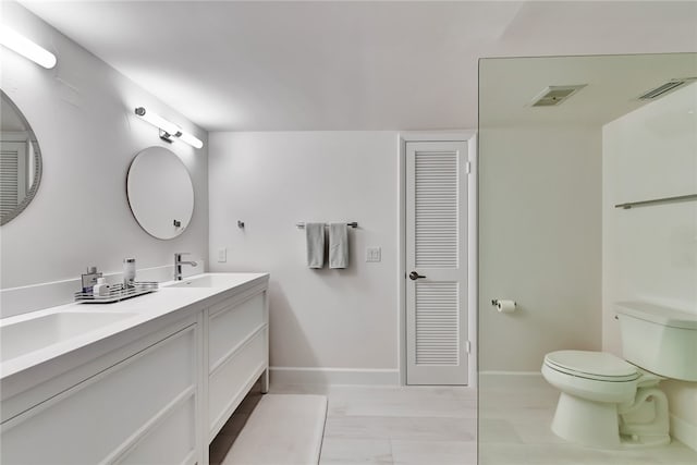 bathroom with toilet and vanity