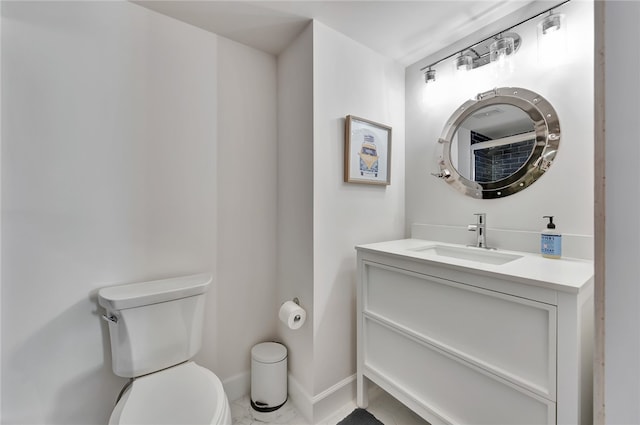 bathroom featuring toilet and vanity