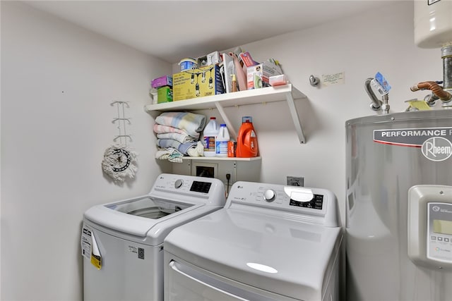 washroom featuring washing machine and dryer and electric water heater