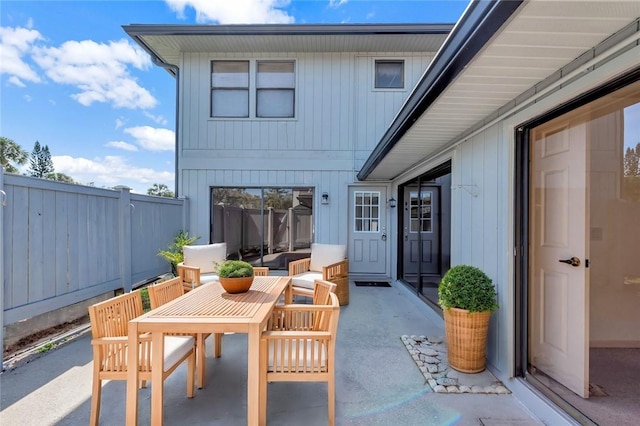 view of patio featuring fence and outdoor dining area