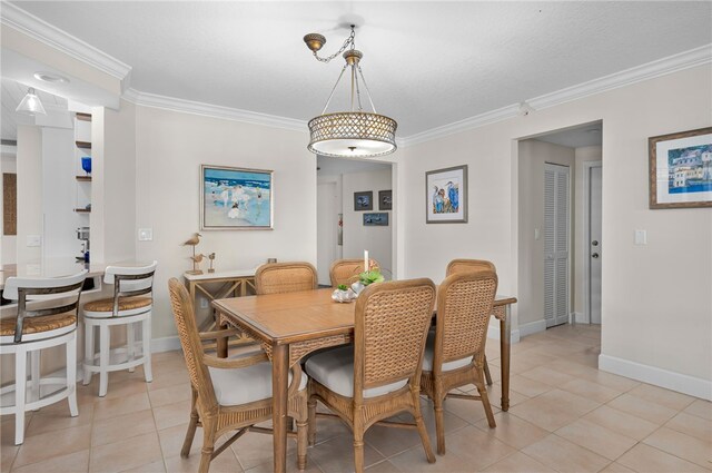 dining room featuring ornamental molding, light tile patterned flooring, and baseboards