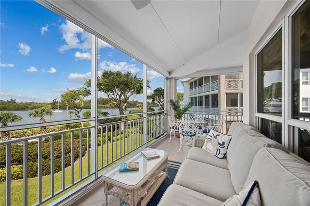 sunroom with a water view and outdoor lounge area