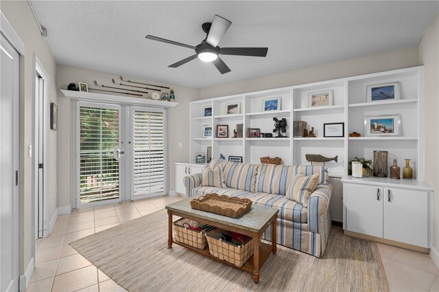 sitting room featuring light tile patterned floors, a ceiling fan, and baseboards