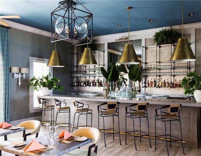 kitchen featuring crown molding, wood finished floors, a chandelier, and recessed lighting