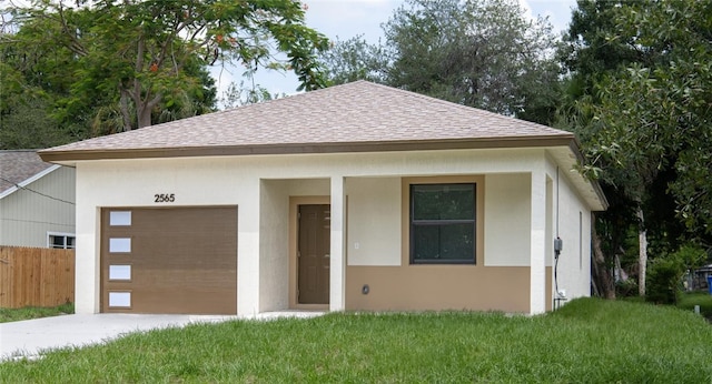 2565 86th Ave, Vero Beach, FL 32966 - view of front facade featuring a garage, roof with shingles, and concrete driveway
