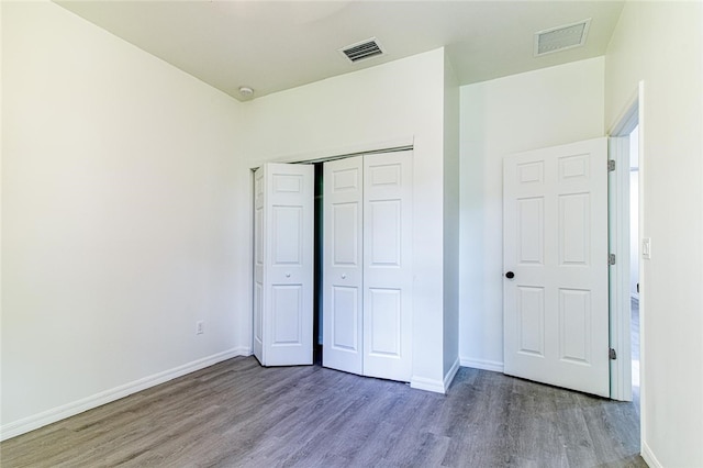 2565 86th Ave, Vero Beach, FL 32966 - unfurnished bedroom featuring wood finished floors and a closet