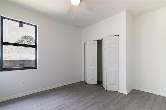 2565 86th Ave, Vero Beach, FL 32966 - unfurnished bedroom featuring wood finished floors and a ceiling fan