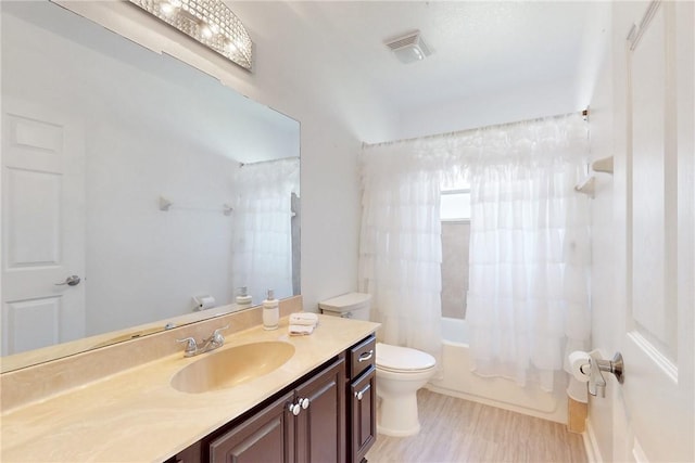 bathroom with shower / bathtub combination with curtain, vanity, toilet, and visible vents