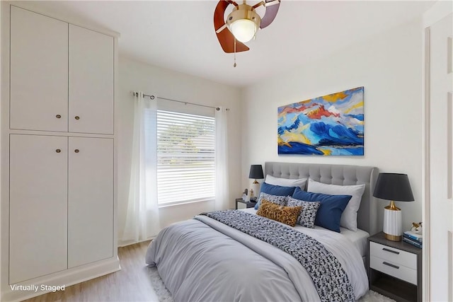 bedroom with ceiling fan and light wood-type flooring