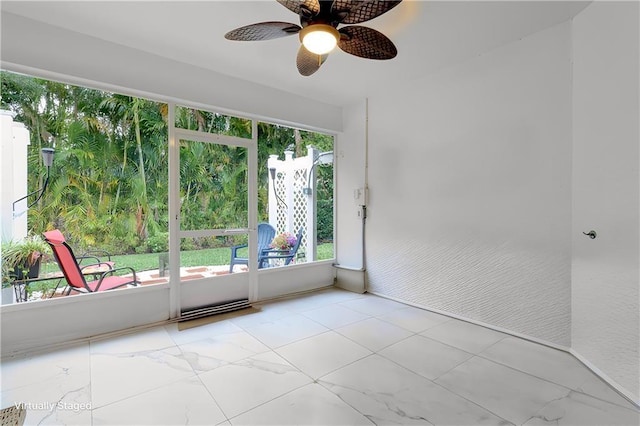 empty room with a ceiling fan and marble finish floor