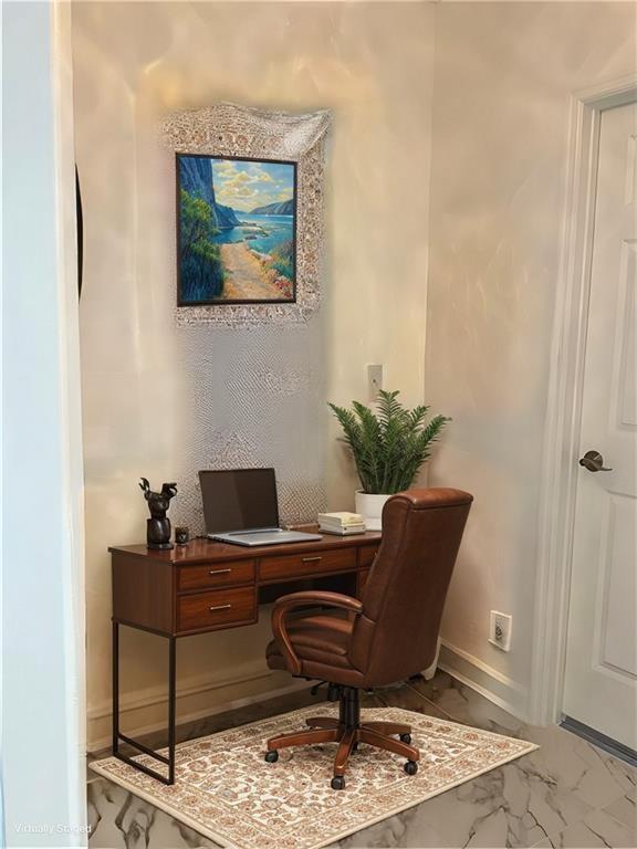office area featuring baseboards and marble finish floor