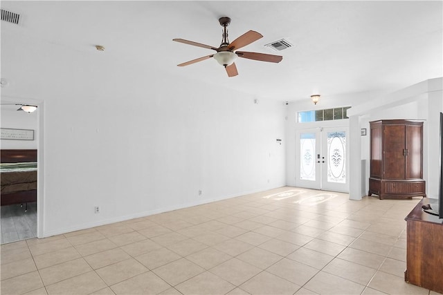 unfurnished living room featuring ceiling fan, french doors, and light tile patterned flooring