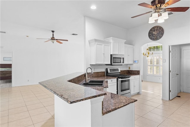 kitchen with sink, light tile patterned floors, white cabinetry, kitchen peninsula, and stainless steel appliances