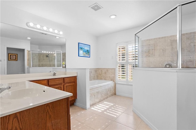 bathroom with vanity, tile patterned floors, and separate shower and tub