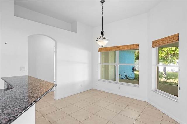 unfurnished dining area with light tile patterned floors