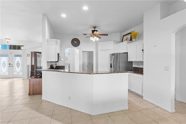 kitchen with french doors, stainless steel refrigerator with ice dispenser, ceiling fan, light tile patterned flooring, and white cabinetry