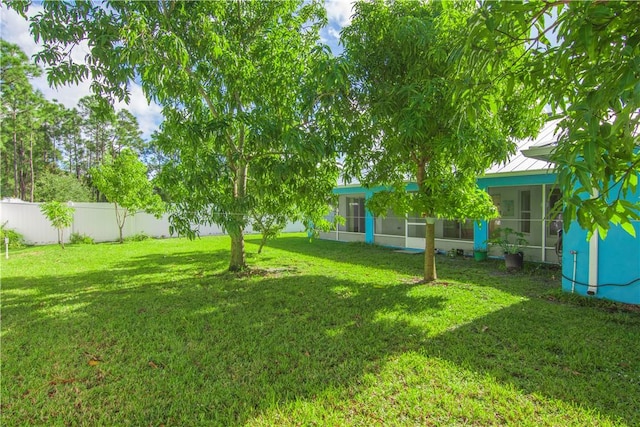 view of yard featuring a sunroom