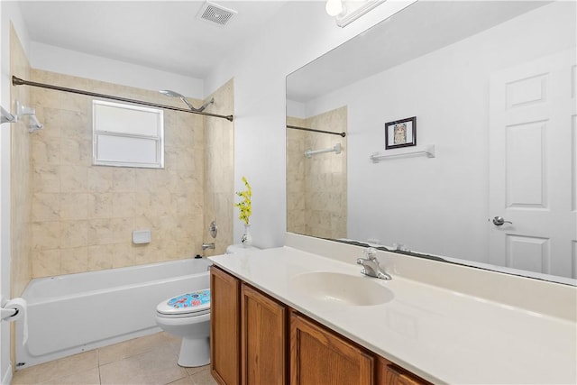 full bathroom with tile patterned flooring, vanity, toilet, and tiled shower / bath combo