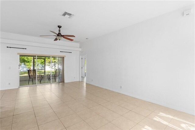 spare room featuring ceiling fan and light tile patterned floors