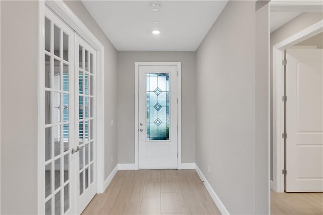 entrance foyer featuring french doors and baseboards