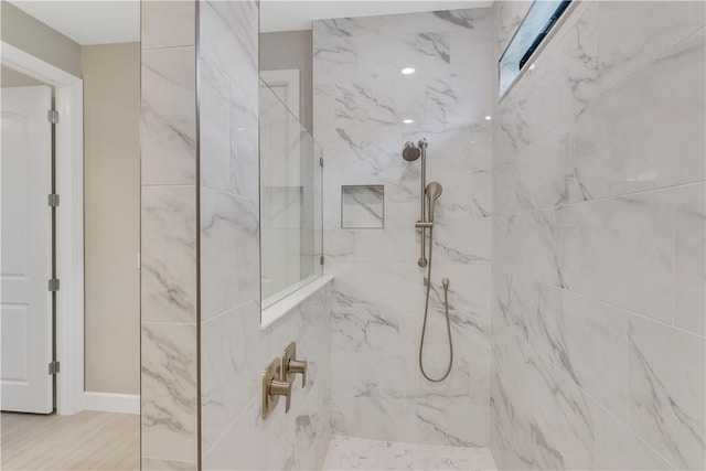 full bathroom with a marble finish shower