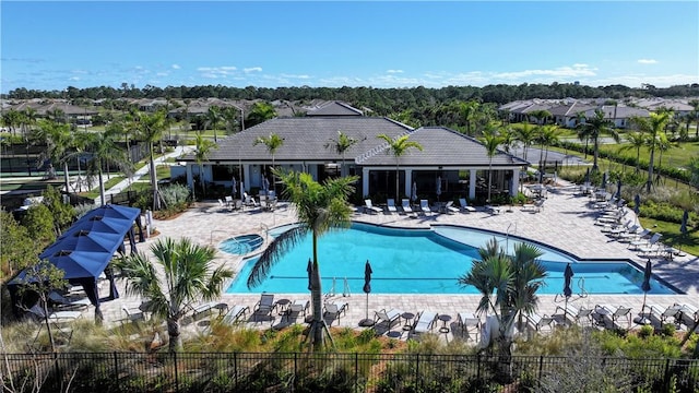 community pool featuring a patio area and fence