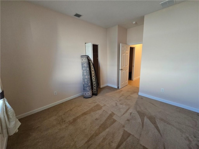 unfurnished bedroom featuring light colored carpet