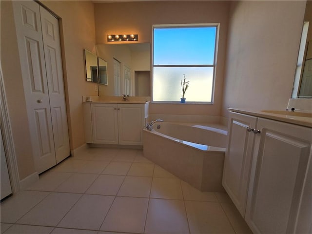 bathroom featuring vanity, tile patterned floors, and a bathing tub