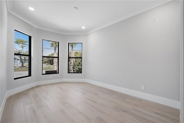 empty room with recessed lighting, baseboards, and light wood finished floors