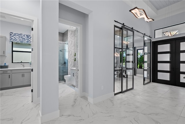 9259 Seaglass Ct, Vero Beach, FL 32963 - foyer entrance featuring light marble finish flooring, french doors, baseboards, and a chandelier