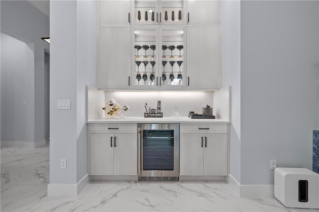 9259 Seaglass Ct, Vero Beach, FL 32963 - indoor bar with beverage cooler, light marble finish flooring, baseboards, and tasteful backsplash