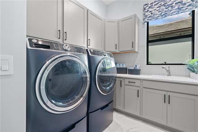 9259 Seaglass Ct, Vero Beach, FL 32963 - washroom featuring cabinet space, washing machine and clothes dryer, and light marble finish flooring