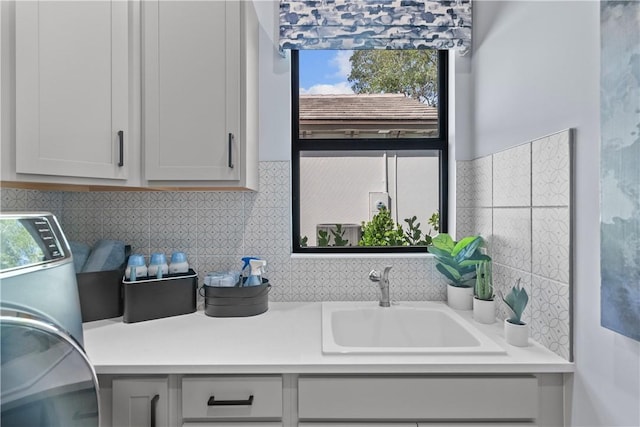 9259 Seaglass Ct, Vero Beach, FL 32963 - laundry area with cabinet space and washer / dryer