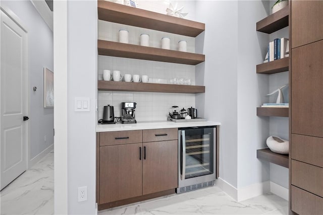 9259 Seaglass Ct, Vero Beach, FL 32963 - indoor dry bar featuring wine cooler, light marble finish floors, backsplash, and baseboards