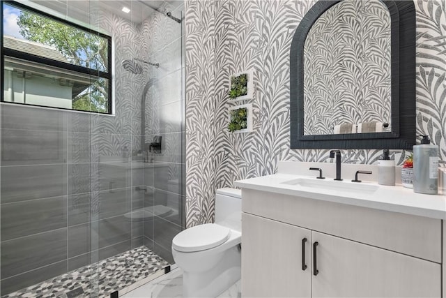 9259 Seaglass Ct, Vero Beach, FL 32963 - full bathroom featuring toilet, vanity, a tile shower, and marble finish flooring