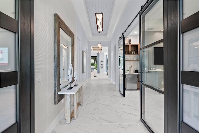 9259 Seaglass Ct, Vero Beach, FL 32963 - hall with a barn door and light marble finish flooring