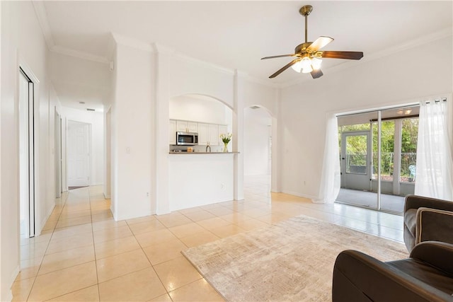 tiled living room featuring ceiling fan and ornamental molding